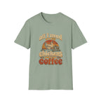 Sage green crewneck t-shirt featuring a vintage-style graphic of a chicken, coop, and sunset with the text All I Need Are My Chickens and Some Coffee.
